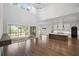 Open-concept living room with large windows, wood floors, and modern kitchen at 584 Indian Hills Pkwy, Marietta, GA 30068