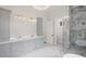 Stylish bathroom featuring double vanities, a glass-enclosed shower, and marble tile flooring at 584 Indian Hills Pkwy, Marietta, GA 30068