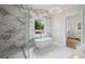 Luxurious main bathroom featuring a free-standing tub, a glass-enclosed shower, and marble accents at 584 Indian Hills Pkwy, Marietta, GA 30068
