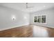 Spacious primary bedroom with hardwood floors, a ceiling fan, and natural light at 584 Indian Hills Pkwy, Marietta, GA 30068