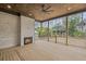 Covered outdoor living space with fireplace, ceiling fan, wood ceiling, and wood floors at 584 Indian Hills Pkwy, Marietta, GA 30068