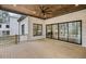 Covered porch with wood floors, brick fireplace, ceiling fan, and sliding glass doors at 584 Indian Hills Pkwy, Marietta, GA 30068