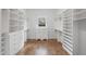 Spacious walk-in closet with custom built-in shelving and drawers at 584 Indian Hills Pkwy, Marietta, GA 30068