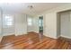 An airy living room featuring hardwood floors and a charming brick fireplace at 946 Crew Sw St, Atlanta, GA 30315