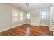Cozy room featuring painted fireplace, laminate floors and natural light from multiple windows at 946 Crew Sw St, Atlanta, GA 30315