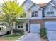 Charming townhome featuring a stone accent, attached garage, and a well-maintained front yard at 1975 Hoods Fort Nw Cir # 24, Kennesaw, GA 30144