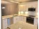 Stylish kitchen with white cabinets, stainless steel appliances, and granite countertops at 1975 Hoods Fort Nw Cir # 24, Kennesaw, GA 30144