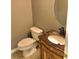Compact powder room featuring a decorative vanity with countertop sink and toilet at 1975 Hoods Fort Nw Cir # 24, Kennesaw, GA 30144