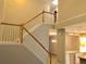 Bright staircase showcasing white railings and wood trim, adjacent to the kitchen at 1975 Hoods Fort Nw Cir # 24, Kennesaw, GA 30144