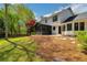 A spacious backyard with lawn, privacy fence, and screen porch enhances outdoor enjoyment at 3040 Greenfield Dr, Marietta, GA 30068