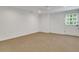 The finished basement offers a door to the exterior, carpeted flooring, and ample natural light at 3040 Greenfield Dr, Marietta, GA 30068