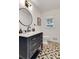 Stylish powder room featuring modern vanity with gold hardware and patterned tile floor at 3040 Greenfield Dr, Marietta, GA 30068