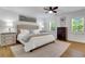 Bright main bedroom suite featuring hardwood floors, modern ceiling fan, and windows with views of greenery at 3040 Greenfield Dr, Marietta, GA 30068