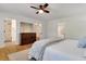 Bright bedroom with hardwood floors, ceiling fan, en-suite bathroom, and large dresser at 3040 Greenfield Dr, Marietta, GA 30068