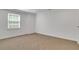 This cozy carpeted bedroom features a window for natural light at 3040 Greenfield Dr, Marietta, GA 30068
