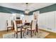Dining area showcases a wood table, modern chandelier, and is adjacent to another updated room at 3040 Greenfield Dr, Marietta, GA 30068