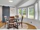 Dining area showcases a modern barn door, a round table, and a bay window with bright natural light at 3040 Greenfield Dr, Marietta, GA 30068
