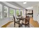 Bright breakfast nook boasts a wooden table, bay window, and an adjacent updated kitchen with white cabinets at 3040 Greenfield Dr, Marietta, GA 30068