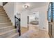 Foyer with staircase and view into living room with hardwood floors and elegant details at 3040 Greenfield Dr, Marietta, GA 30068