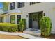 Charming home exterior showing the front door framed by sidelights and manicured bushes at 3040 Greenfield Dr, Marietta, GA 30068