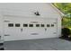 Close-up of the white garage door with decorative hardware and lighting at 3040 Greenfield Dr, Marietta, GA 30068