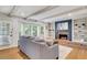 Bright living room with brick fireplace, built-in shelves, bay window and hardwood floors at 3040 Greenfield Dr, Marietta, GA 30068