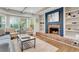 Bright living room with brick fireplace, built-in shelves, bay window and hardwood floors at 3040 Greenfield Dr, Marietta, GA 30068