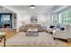 Bright living room featuring a fireplace, built-in shelves, and large bay window with shutters at 3040 Greenfield Dr, Marietta, GA 30068