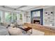 Bright living room with brick fireplace, built-in shelves, bay window and hardwood floors at 3040 Greenfield Dr, Marietta, GA 30068
