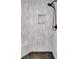 Modern shower featuring a gray patterned tile wall and a black hexagon patterned floor at 3040 Greenfield Dr, Marietta, GA 30068