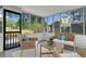 Enclosed sunroom featuring wicker furniture, a ceiling fan, and views of the backyard at 3040 Greenfield Dr, Marietta, GA 30068