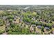 An aerial view of a neighborhood showcasing lovely homes nestled among lush greenery and trees at 629 Gold Valley Pass, Canton, GA 30114