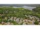 Aerial view of a community with beautiful homes surrounded by lush green trees and a serene lake at 629 Gold Valley Pass, Canton, GA 30114