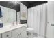 Clean and functional bathroom with white fixtures, a shower-tub combination, and ample storage space at 629 Gold Valley Pass, Canton, GA 30114
