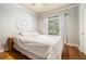 Cozy bedroom with hardwood floors, a comfortable bed, and a window offering serene views at 629 Gold Valley Pass, Canton, GA 30114