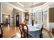 Dining area featuring a chandelier, wainscoting, and access to other living spaces at 629 Gold Valley Pass, Canton, GA 30114