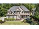 Beautiful two-story home featuring a covered porch, bay window, and lush green lawn at 629 Gold Valley Pass, Canton, GA 30114