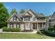 Inviting home featuring a stone-accented porch and beautifully maintained landscaping at 629 Gold Valley Pass, Canton, GA 30114