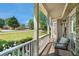 Charming front porch view with seating and stone accents and manicured lawn at 629 Gold Valley Pass, Canton, GA 30114