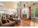 Cozy living room with fireplace, large windows, and hardwood floors and open layout at 629 Gold Valley Pass, Canton, GA 30114