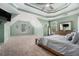 Inviting main bedroom with a tray ceiling, natural light, and a comfortable king-size bed, ideal for relaxation at 629 Gold Valley Pass, Canton, GA 30114