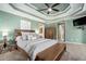 Tranquil main bedroom with natural light, a tray ceiling, and a comfortable bed, creating a peaceful retreat at 629 Gold Valley Pass, Canton, GA 30114