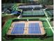 Aerial view of the community's tennis court complex featuring multiple well-lit courts and a charming clubhouse at 629 Gold Valley Pass, Canton, GA 30114