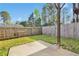 Nice backyard with a concrete patio area surrounded by green grass, and a wooden privacy fence at 7545 Roseberry Way, Lithonia, GA 30038