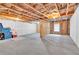 Spacious unfinished basement featuring concrete floors and exposed ceiling joists and framed walls at 7545 Roseberry Way, Lithonia, GA 30038