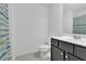Modern bathroom featuring stylish vanity and shower with striped curtain at 7545 Roseberry Way, Lithonia, GA 30038