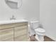 Bathroom with modern vanity, sink, faucet, mirror and toilet at 7545 Roseberry Way, Lithonia, GA 30038