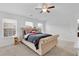 Bedroom with a tufted headboard, windows and plush carpeting at 7545 Roseberry Way, Lithonia, GA 30038