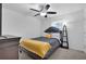 Comfortable bedroom featuring a ceiling fan and a well-lit window at 7545 Roseberry Way, Lithonia, GA 30038