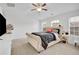 Inviting primary bedroom with a ceiling fan, windows and plush carpeting at 7545 Roseberry Way, Lithonia, GA 30038